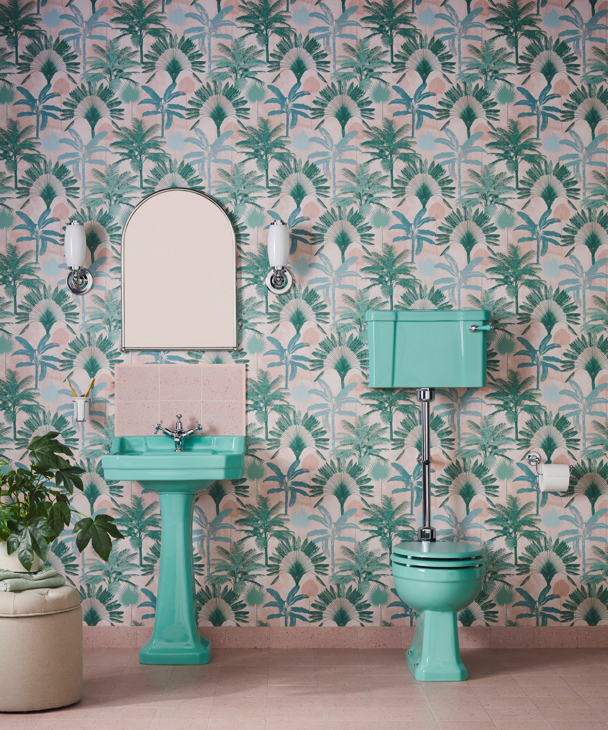 bright green sink and toilet in bathroom with bold green floral wallpaper