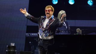 Elton John gestures to the crowd during a performance of his Farewell Yellow Brick Road Tour in Las Vegas, Nevada.