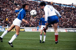 France's Bernard Lacombe heads the ball past Italy's Mauro Bellugi in a game at the 1978 World Cup.