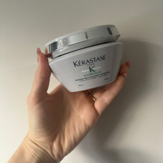 Rebecca holding a tub of the Kérastase Symbiose Masque