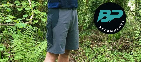 A man wearing Rapha Explore Shorts in a wood