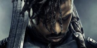 Black Panther Michael B. Jordan Killmonger solemn pose with weapons