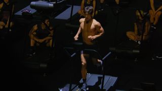 Screenshot of Netflix showing one of the competitors running on a treadmill in Physical: 100 season 2 episode 1.