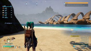 A player stands on a sandy beach, looking out at a giant skeleton somewhere offshore
