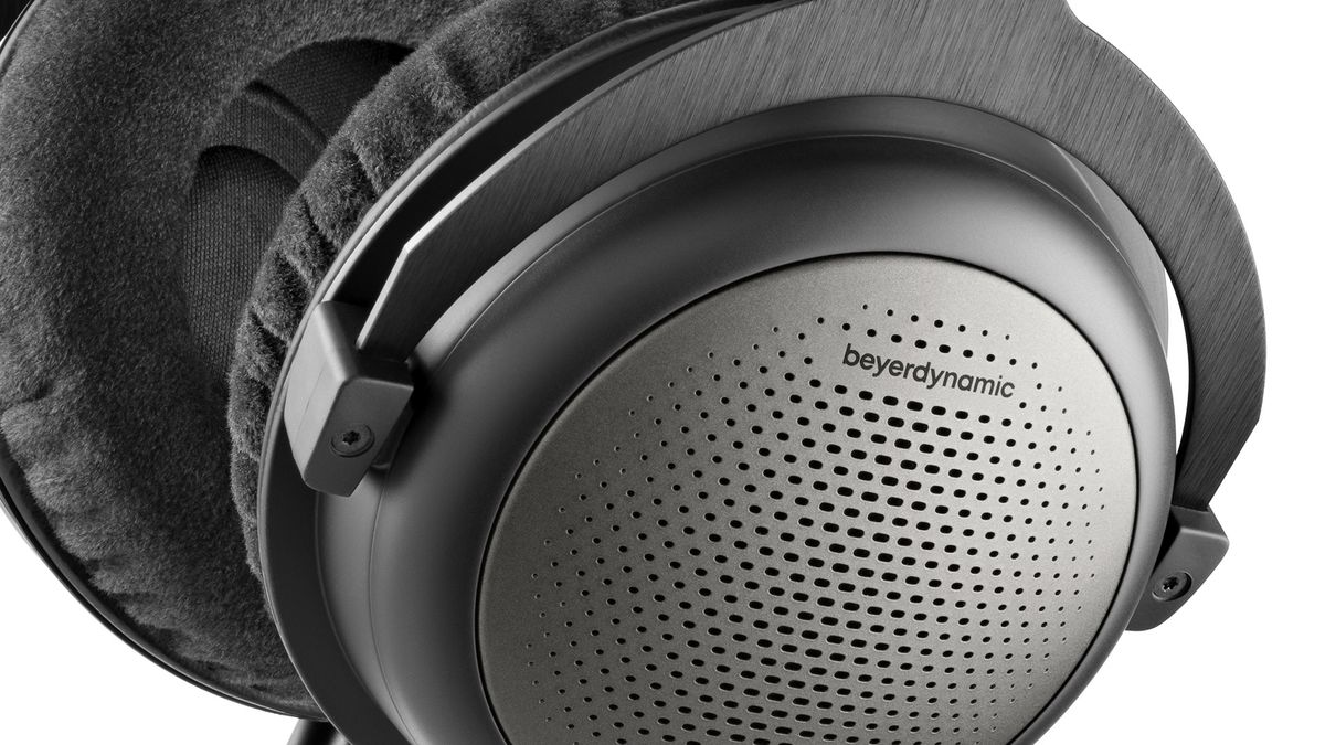 A close-up of the ear cup on a pair of Beyerdynamic T1 (3rd Gen). They are grey and black with fabric cushioning.