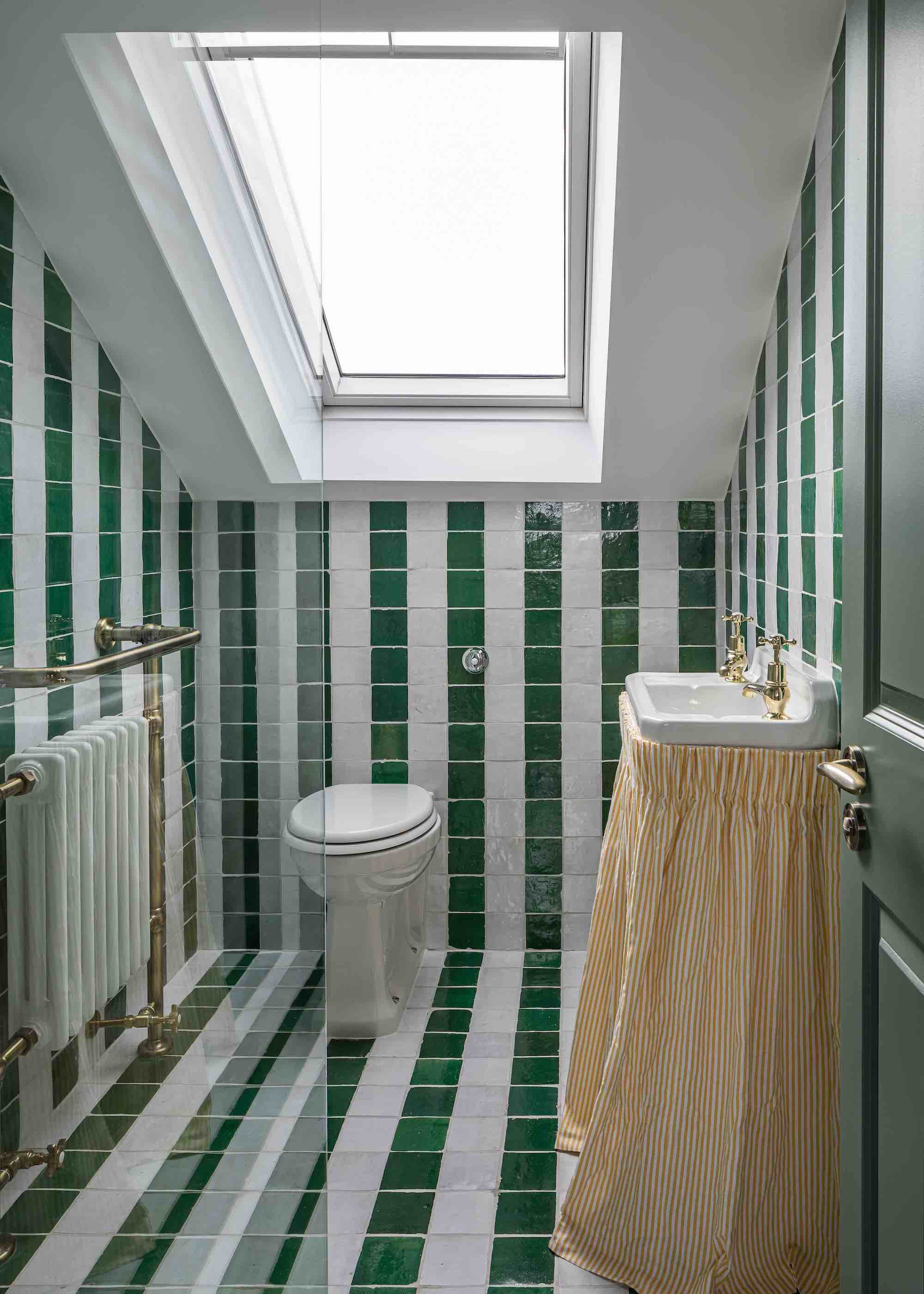 loft bathroom with striped tiles and curtained sink