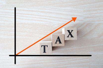 x and y axis with the word tax under a rising arrow