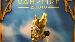 Campfire Audio Trifecta in-ear headphones with skyline backdrop