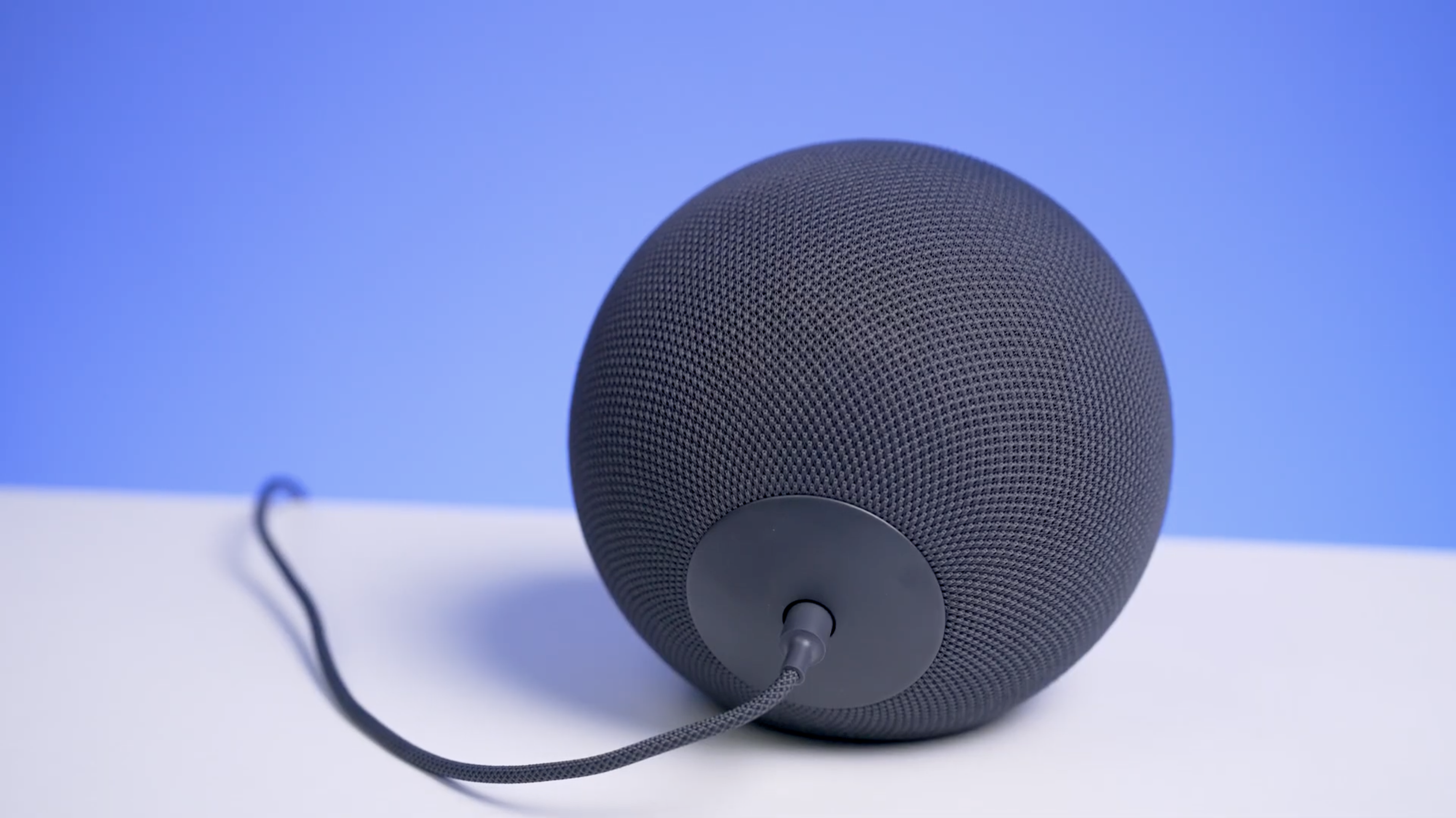 Echo Studio on a white table with a blue background