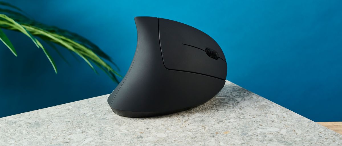 The Anker 2.4G Wireless Vertical Ergonomic Mouse on a stone surface with a blue wall in the background