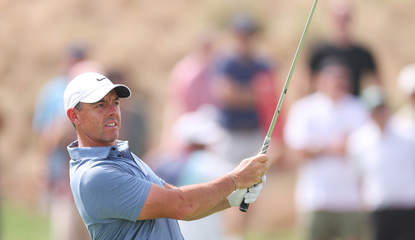 Rory McIlroy hits a wedge shot and watches its flight