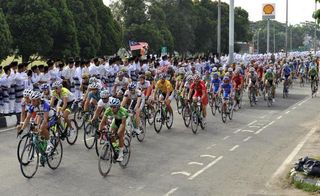 The Tour de Langkawi peloton rides past enourmous crowds on the roadside