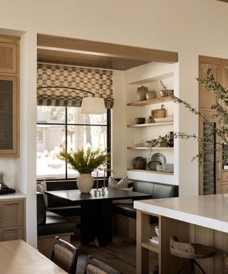 Breakfast Nook with neutral shelving and black table, roman light and marble countertop