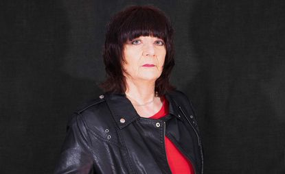 portrait of Cosey Fanni Tutti with a leather jacket and red shirt