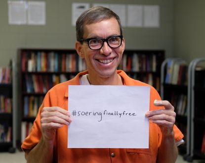 Jens Soering holds up a sign that he plans to use for his social media after he's deported back to Germany, where he hopes to be a motivational speaker. Soering is being detained at the U.S. Immigration and Customs Enforcements Farmville Detention Center in Farmville, VA, Friday, December 6, 2019