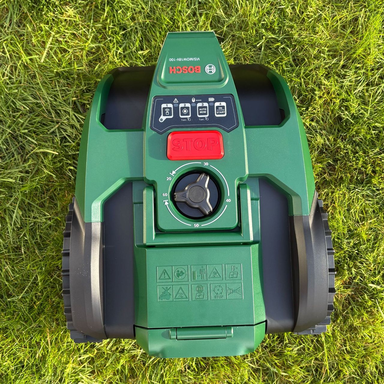 Top view of Bosch VISIMOW18V-100 on grass lawn