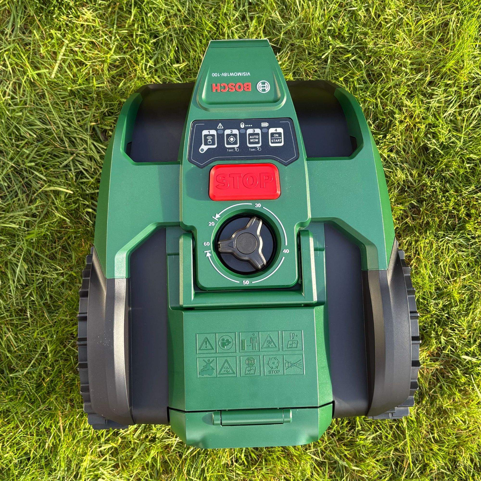 Top view of Bosch VISIMOW18V-100 on grass lawn