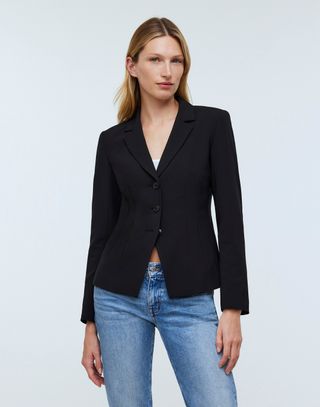 Madewell model in cropped black blazer and blue jeans