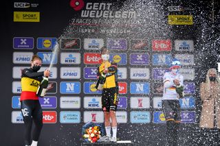 WEVELGEM BELGIUM MARCH 28 Podium Lotte Kopecky of Belgium and Team Liv Racing Marianne Vos of Netherlands and Team Jumbo Visma Lisa Brennauer of Germany and Ceratizit WNT Pro Cycling Team Celebration during the 10th GentWevelgem In Flanders Fields 2021 Womens Elite a 1417km race from Ypres to Wevelgem Mask Champagne Covid Safety Measures GWE21 GWEWomen FlandersClassic UCIWWT on March 28 2021 in Wevelgem Belgium Photo by Luc ClaessenGetty Images