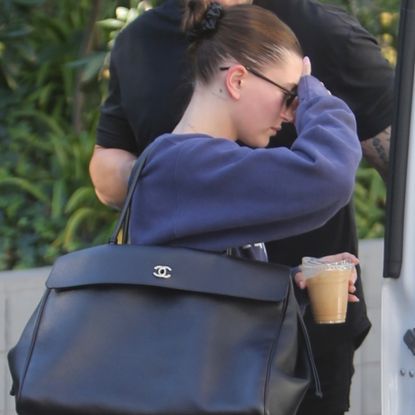 Hailey Bieber visited a pilates class in New Balance 1906r sneakers and an extra-large Chanel Flap tote bag