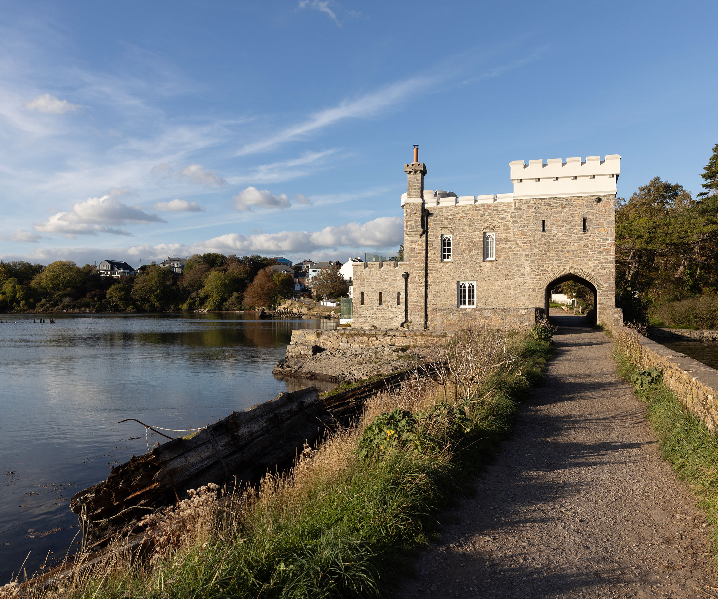 exterior of a renovated castle overlooking a waterway