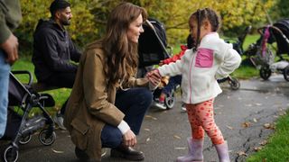 Kate Middleton talking with a young girl