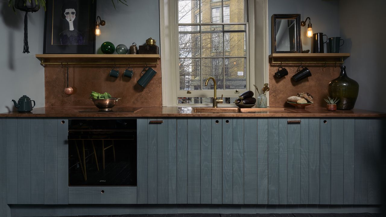 Navy devol kitchen with cooper backsplash