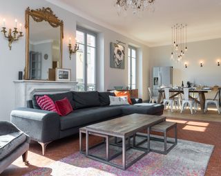 A living room wall lighting idea by Fritz Fryer Lighting with brass Baroque style mirror on mantel with similarly-styled wall lights