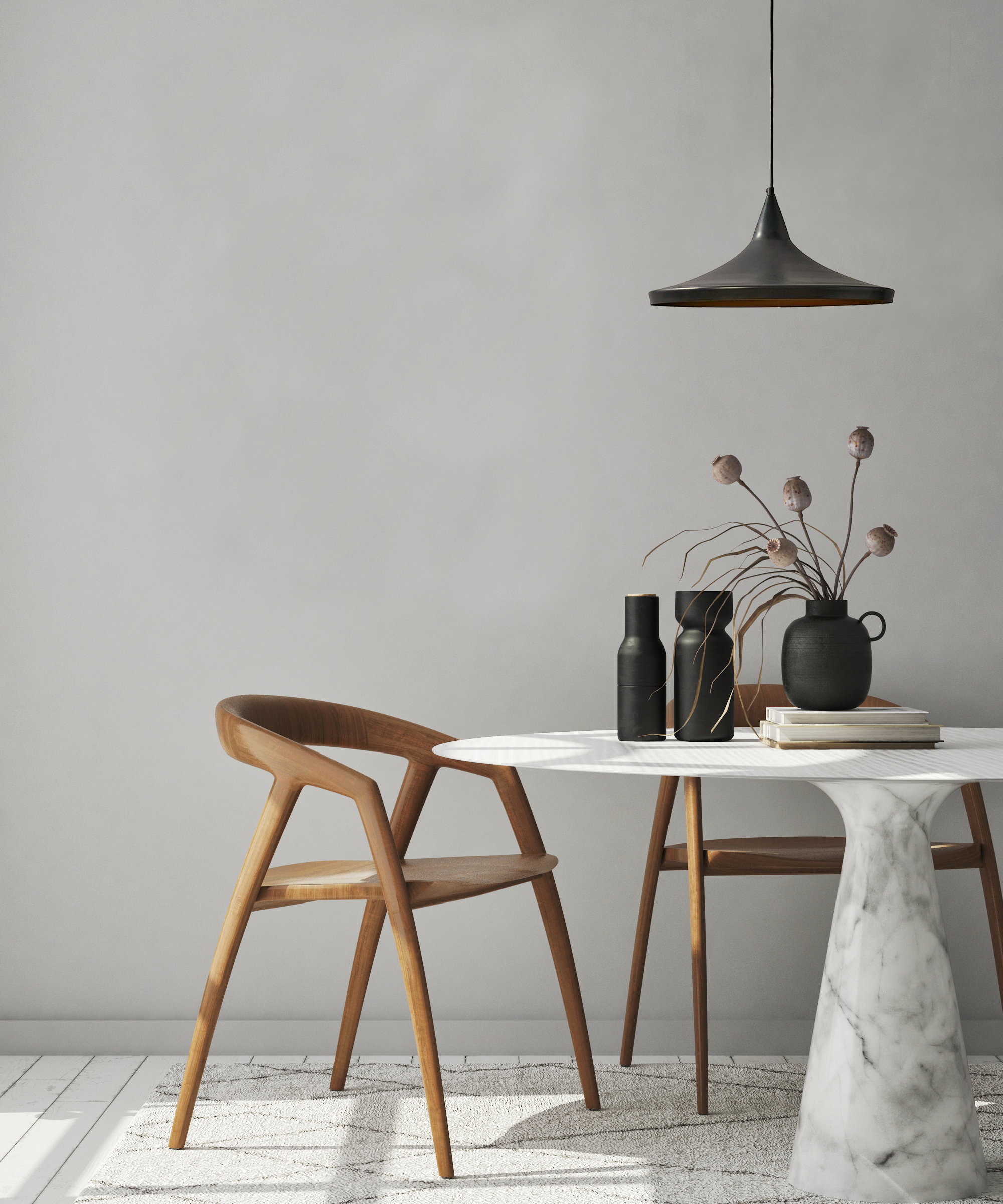 Large matt black pendant light above white marble table and wooden chairs