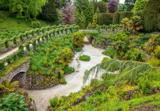 The grotto, or fern dell, with stepping stones in the river of gravel. Next for restoration will be removal of the ivy that blocks from the view from the path. Brodsworth Hall, South Yorkshire. ©Clive Nichols.