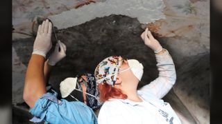 Two researchers carry out restorative work at one of the tombs in Blaundos.
