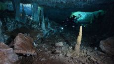 With only a flashlight to light the way, a CINDAQ diver explores the ancient ochre mine. At the end of the last ice age, these caves were dry, but would have been devoid of any natural light.