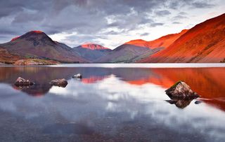 The Scafell range across the reflective waters of Wast Water in the Lake District National Park, Cumbria