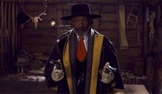 The Hateful Eight Samuel L. Jackson stands with two guns drawn at the camera