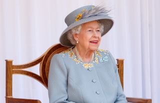 Queen watches a flypast by the RAF Red Arrows as she attends a military parade