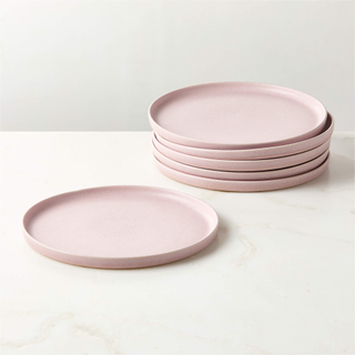 stack of plates and one lone plate in a dusty pink color