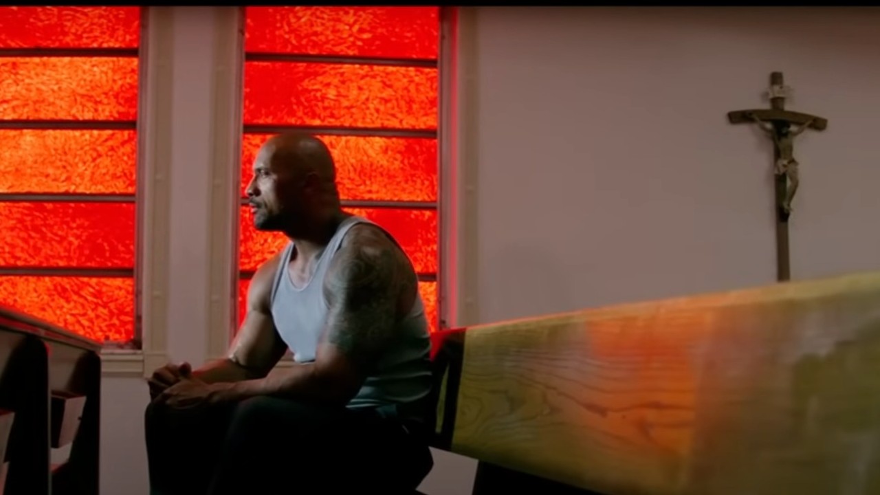 Dwayne Johnson sitting in a church in Pain &amp;amp; Gain