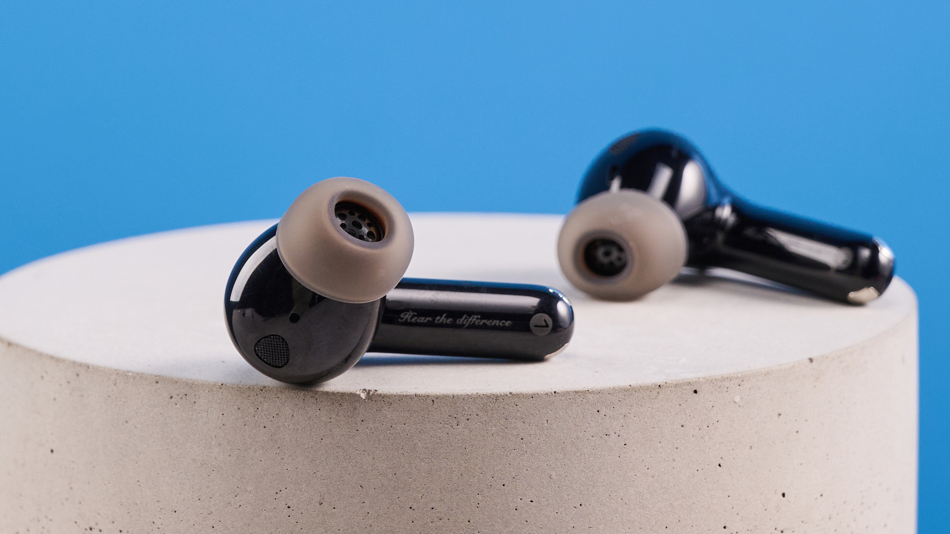 the soundpeats air5 pro earbuds in black and bronze with a black charging case and ear tips