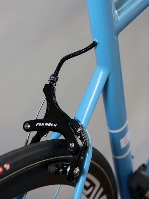 The rear brake line is routed through the top tube on this Rob English bike and exits right behind the seat tube.