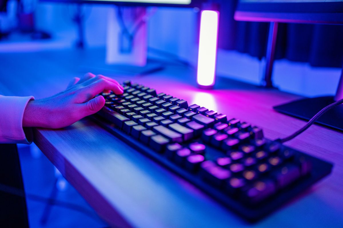 Millennial-aged man playing in an online E-sports tournament on his computer