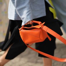 Woman holding orange bag