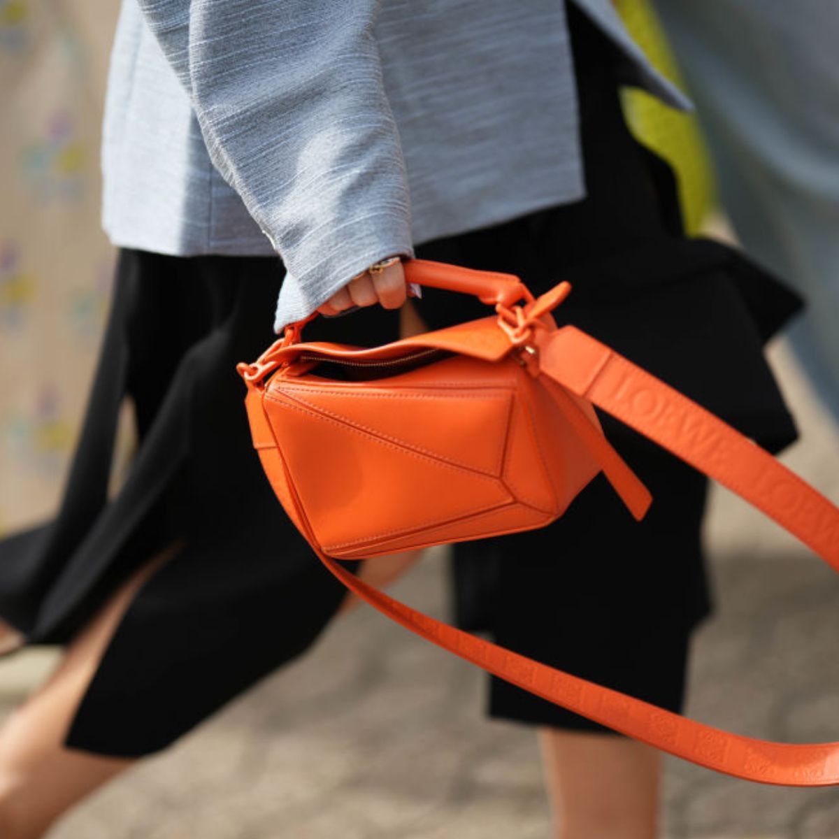 Woman holding orange bag