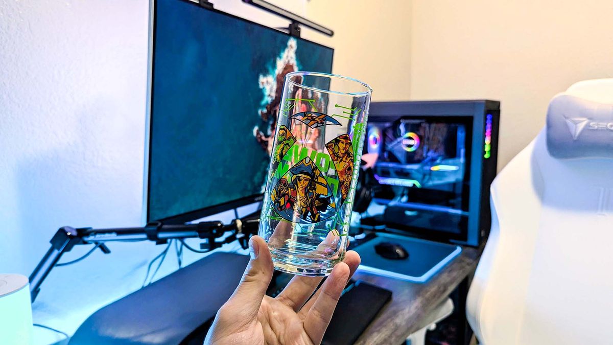 The main Xbox x IHOP collectible glass held in a hand, featuring the Xbox logo, "Power Your Dreams," and art from four Xbox games.