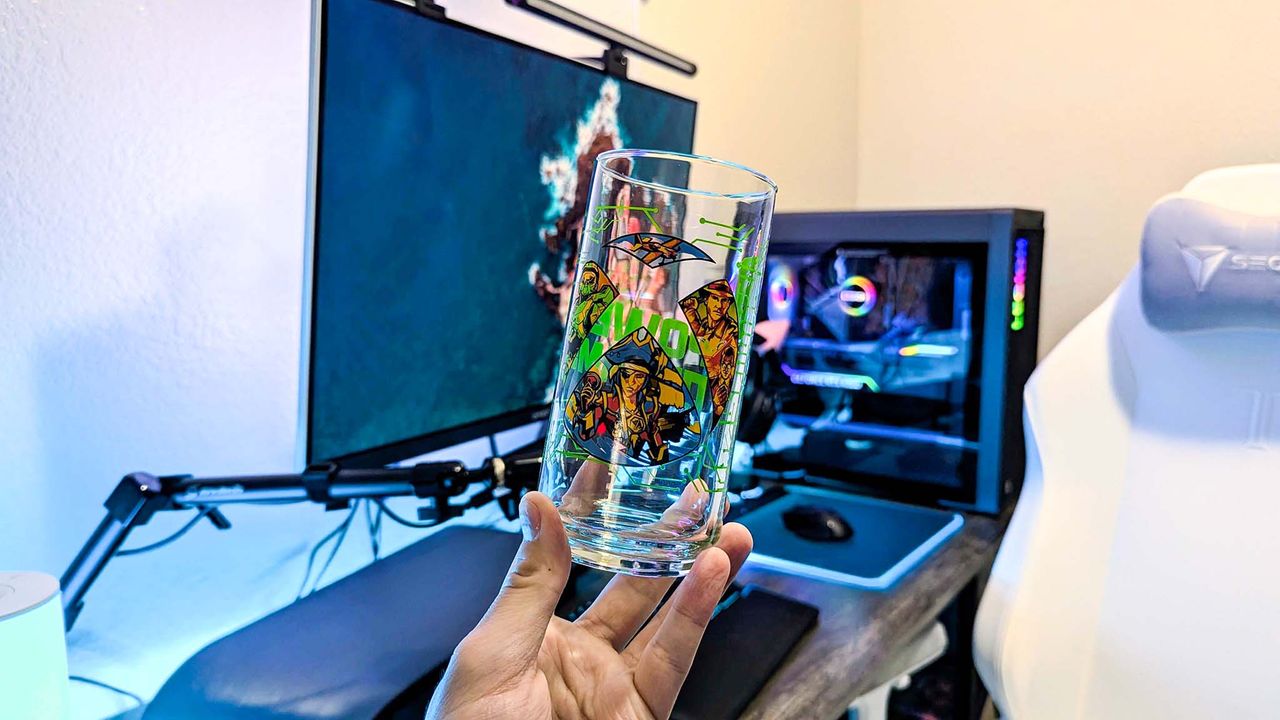 The main Xbox x IHOP collectible glass held in a hand, featuring the Xbox logo, "Power Your Dreams," and art from four Xbox games.