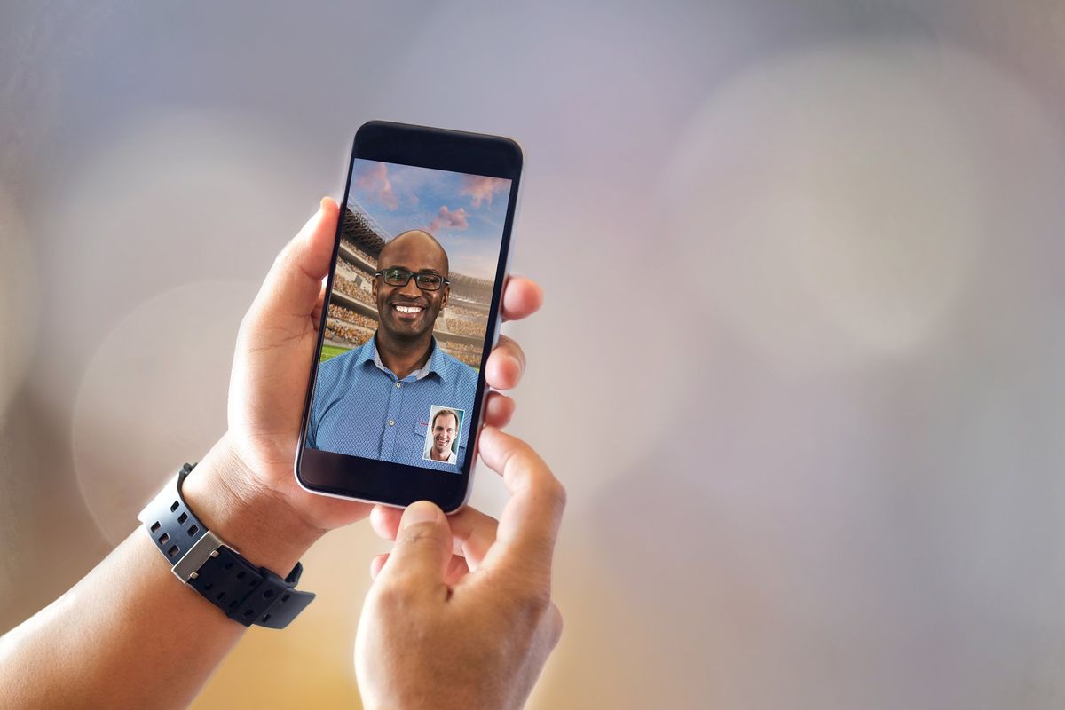 Close up of man with smartphones with blurred background. Communication and Technology Concept.