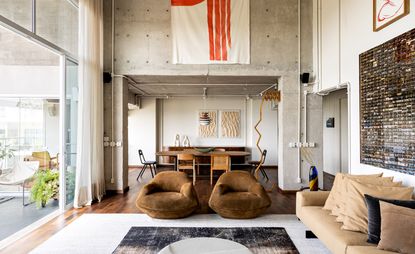 Concrete, stone and wood bring rich tactility to an apartment renovation in Brazil 