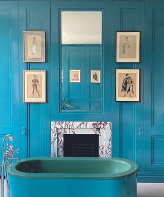 Blue bathroom with freestanding bath and gallery wall