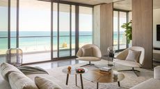 Neutral living room with sculptural shaped furniture in Miami beachside apartment