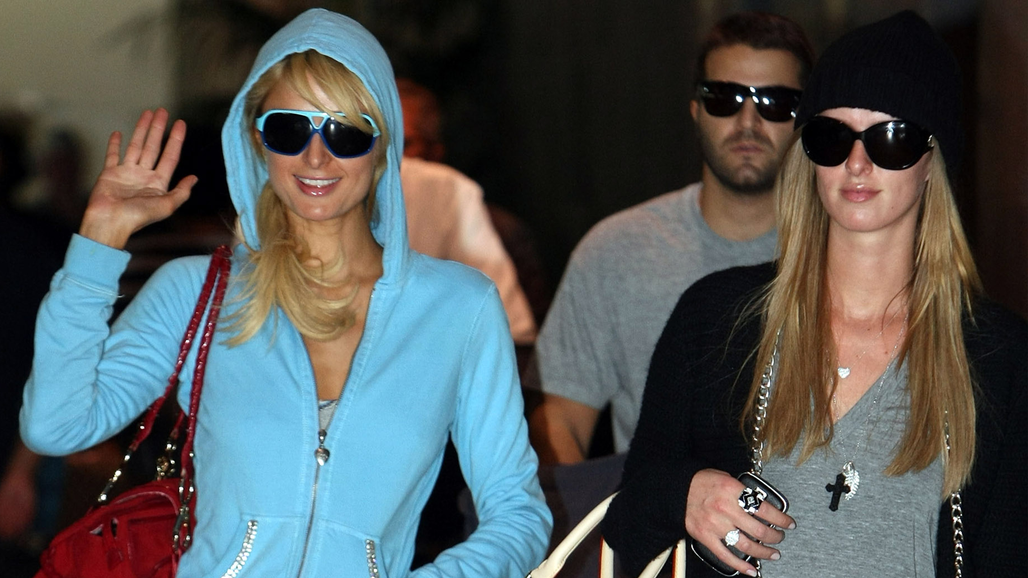 Paris Hilton and Nicky Hilton wear tracksuits and tall UGG boots while at the airport.