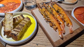 Gambas Al Ajillo, bread and tomato dishes from the Paco Tapas Chef’s Menu